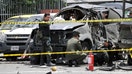 A bomb intended for a hardline former interior minister killed two of his bodyguards and injured at least  people.